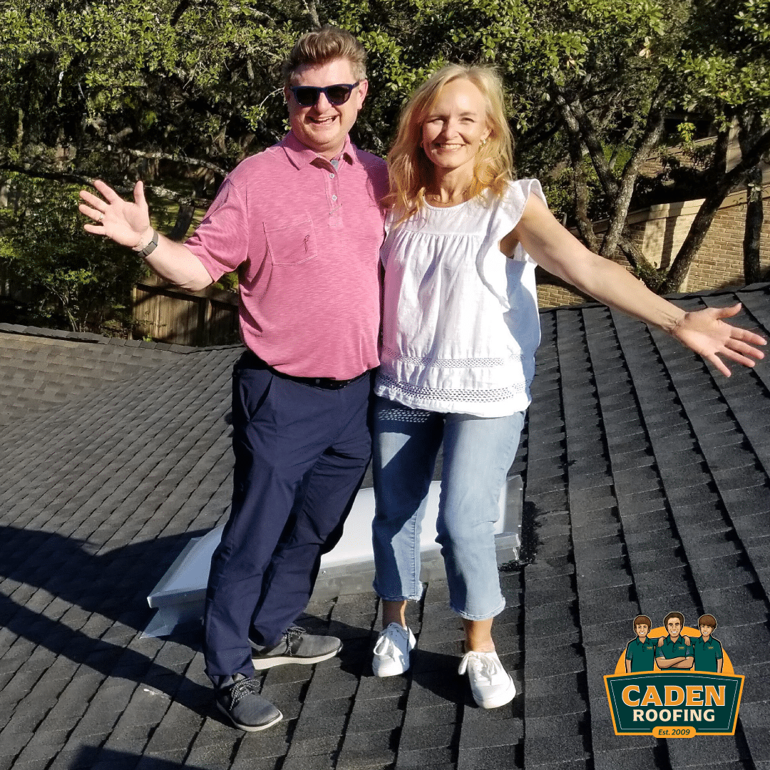Couple celebrating their new GAF Timberline HDZ Charcoal roof in Northwest Hills, Austin, installed by Caden Roofing