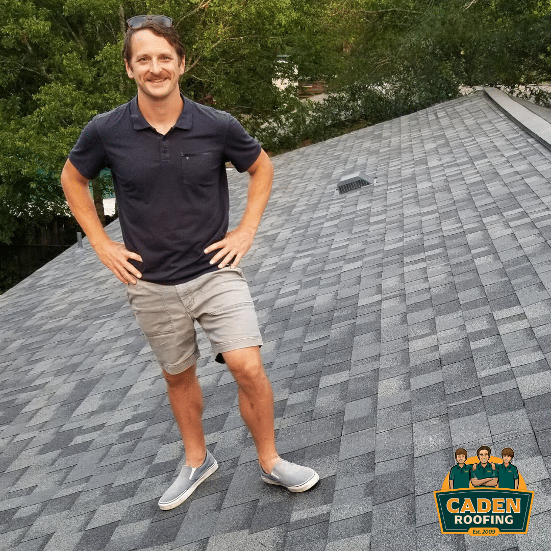 Caden Roofing customer standing on his new Owens Corning Duration Estate Gray shingle roof in Zilker, Central Austin